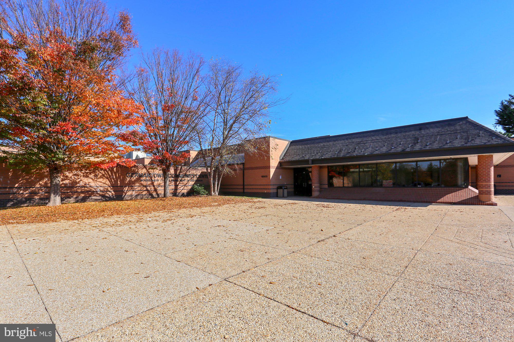 12824 Clarksburg Square Road, Unit 102 Clarksburg, MD 20871 - Photo 74 of 75 a front view of a house with a yard and garage