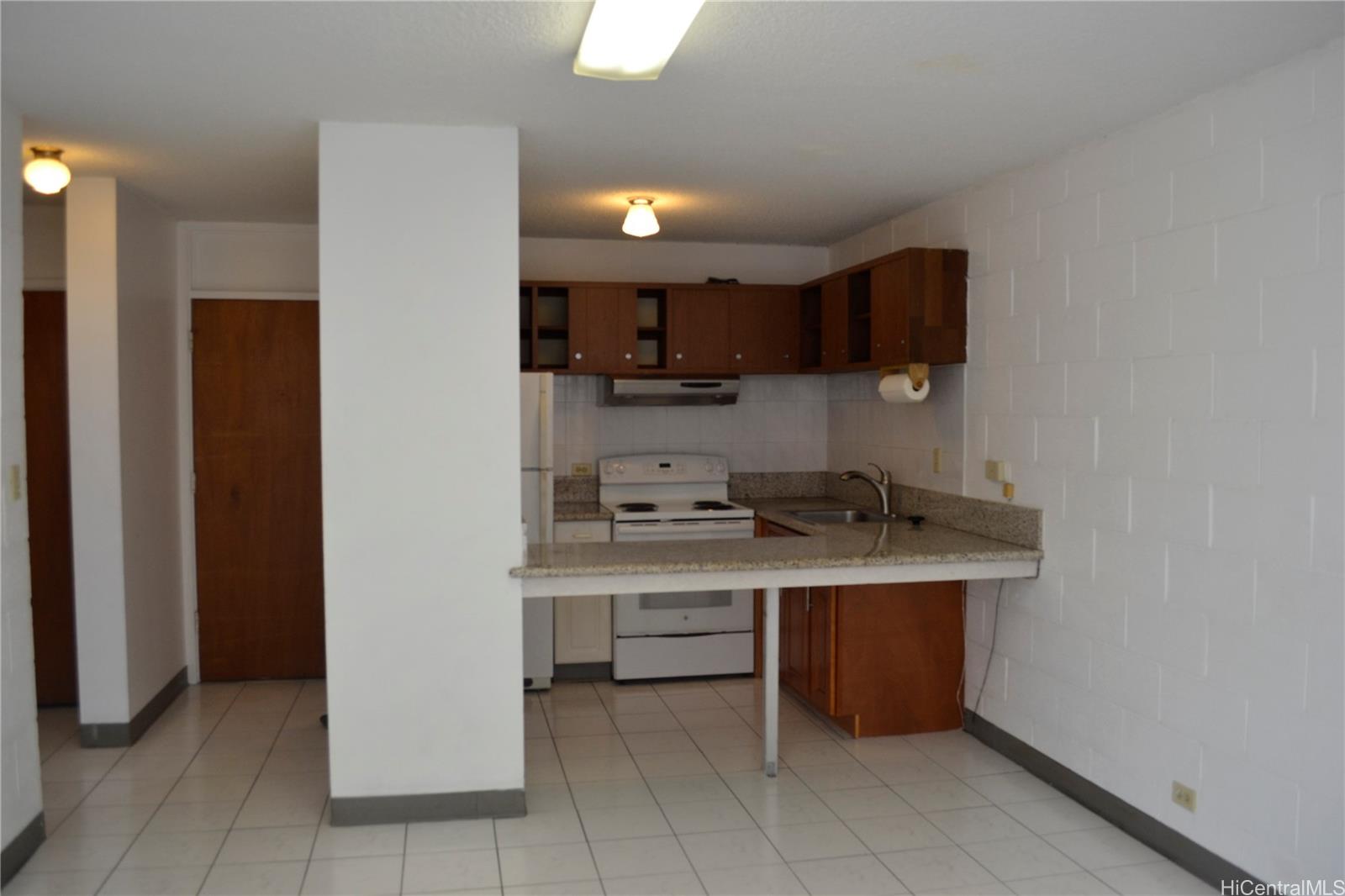 a kitchen with a sink a stove and a refrigerator