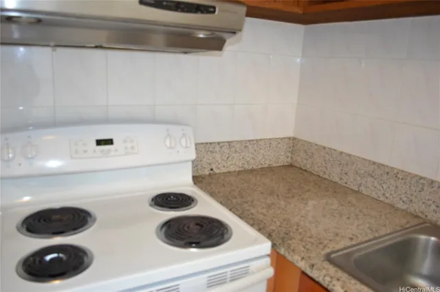 a close view of sink and cabinets