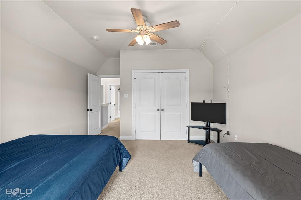 946 Maize Street Bossier City, LA 71111 - Photo 37 of 39 a bedroom with a bed and a potted plant