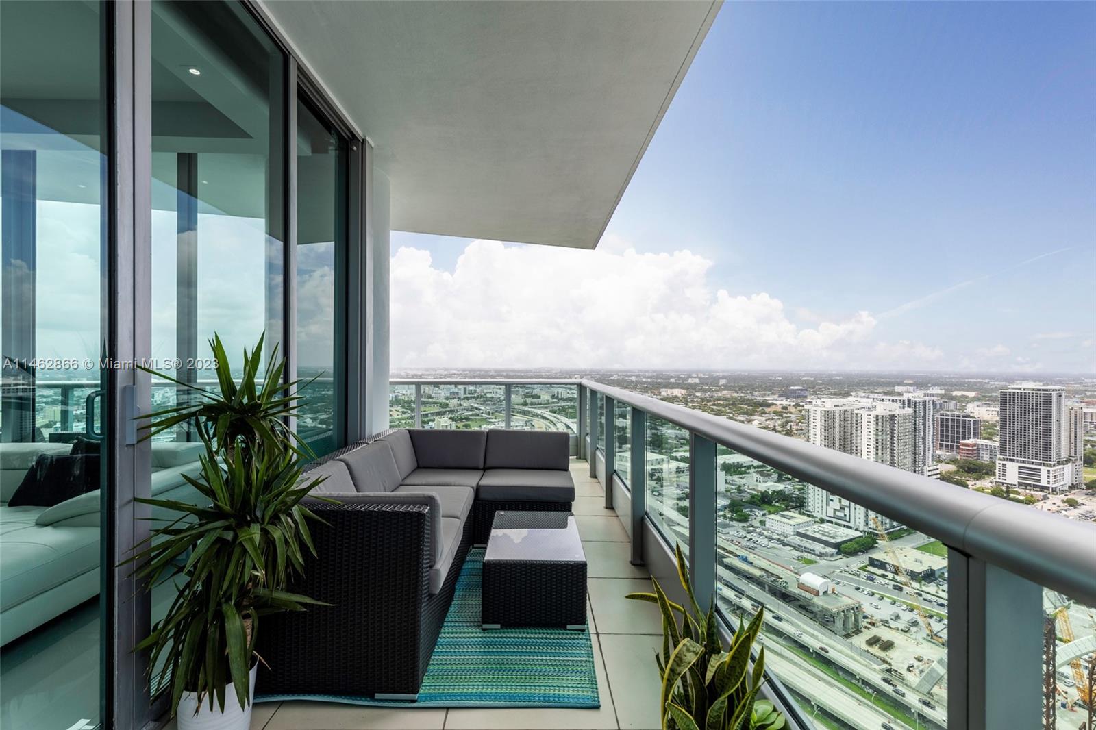 a view of a balcony with furniture and wooden deck
