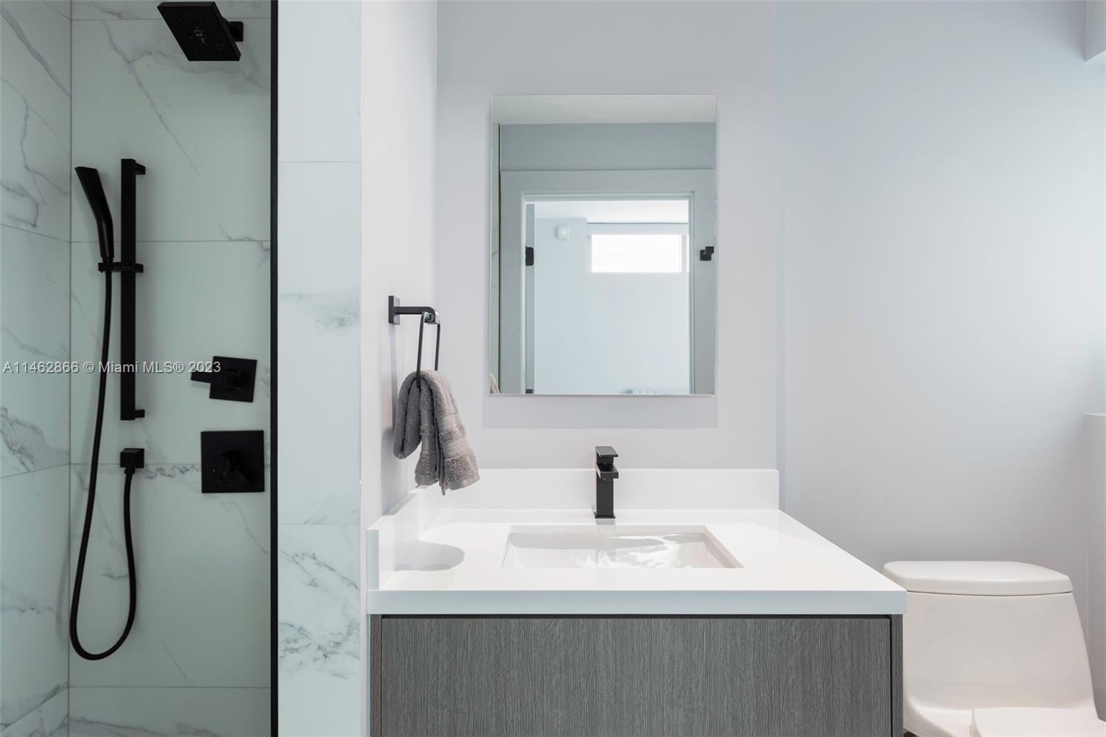 900 Biscayne Boulevard, Unit 5012 Miami, FL 33132 - Photo 11 of 27 a bathroom with a sink vanity mirror and toilet