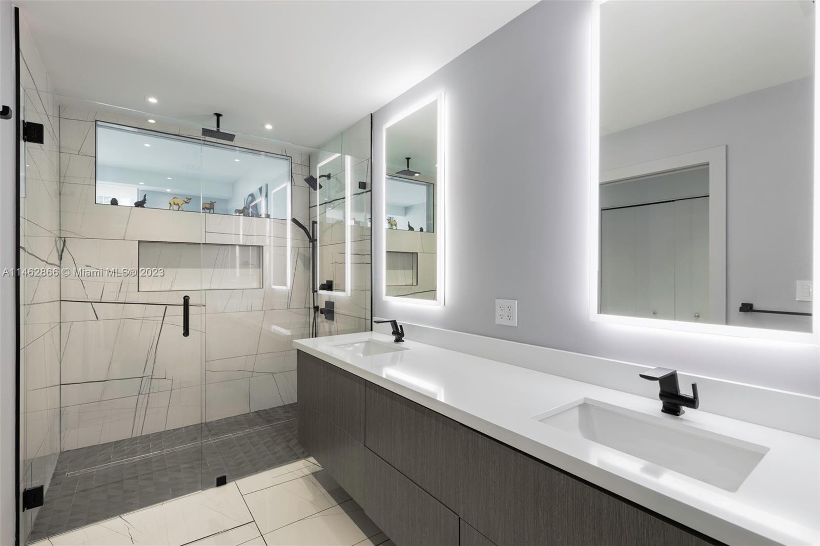 900 Biscayne Boulevard, Unit 5012 Miami, FL 33132 - Photo 15 of 27 a bathroom with a double vanity sink mirror and shower