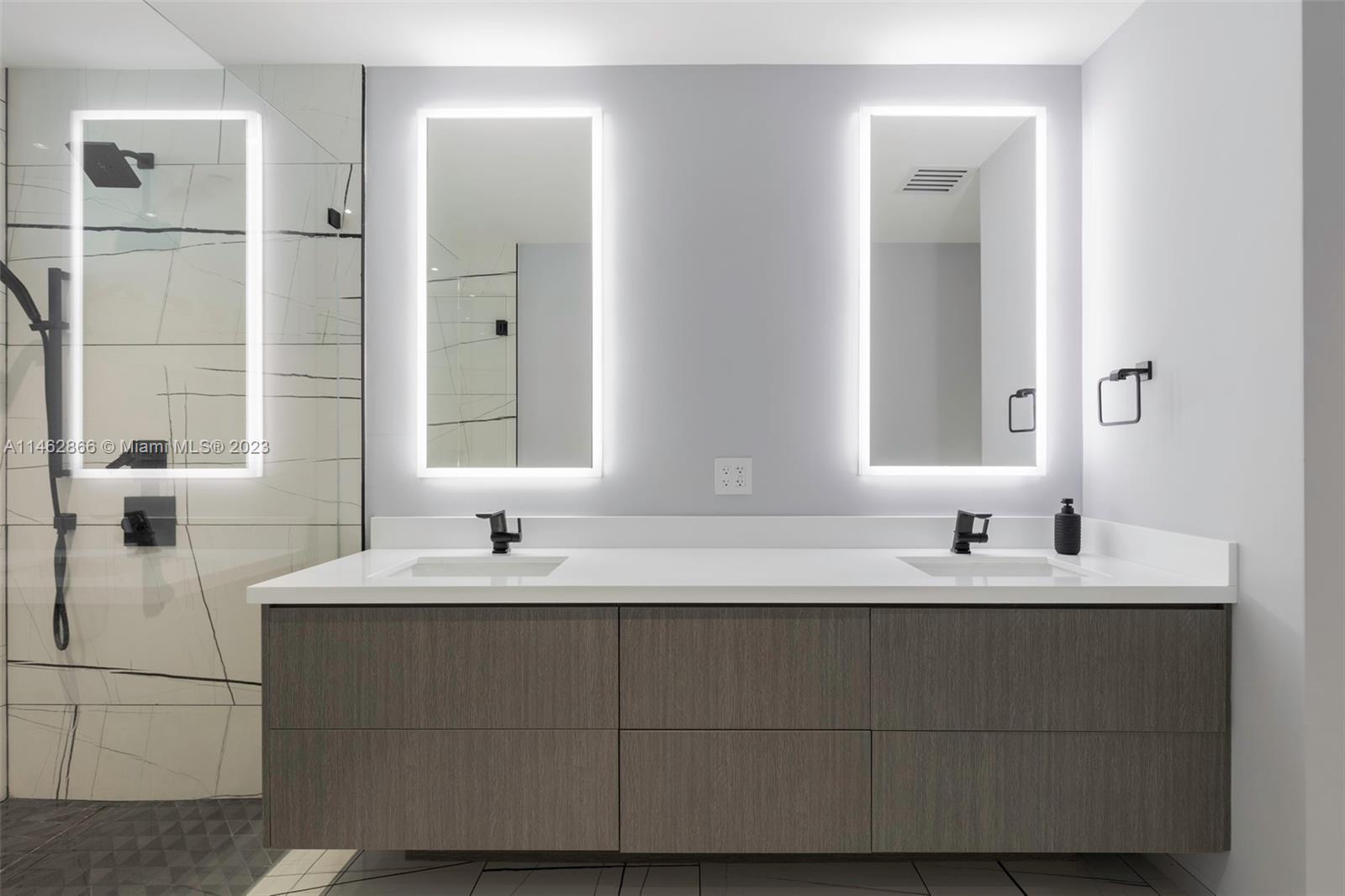 900 Biscayne Boulevard, Unit 5012 Miami, FL 33132 - Photo 16 of 27 a bathroom with a double vanity sink and mirror