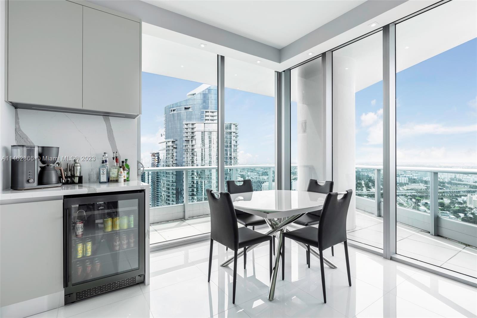 900 Biscayne Boulevard, Unit 5012 Miami, FL 33132 - Photo 8 of 27 a dining room with furniture and a floor to ceiling window
