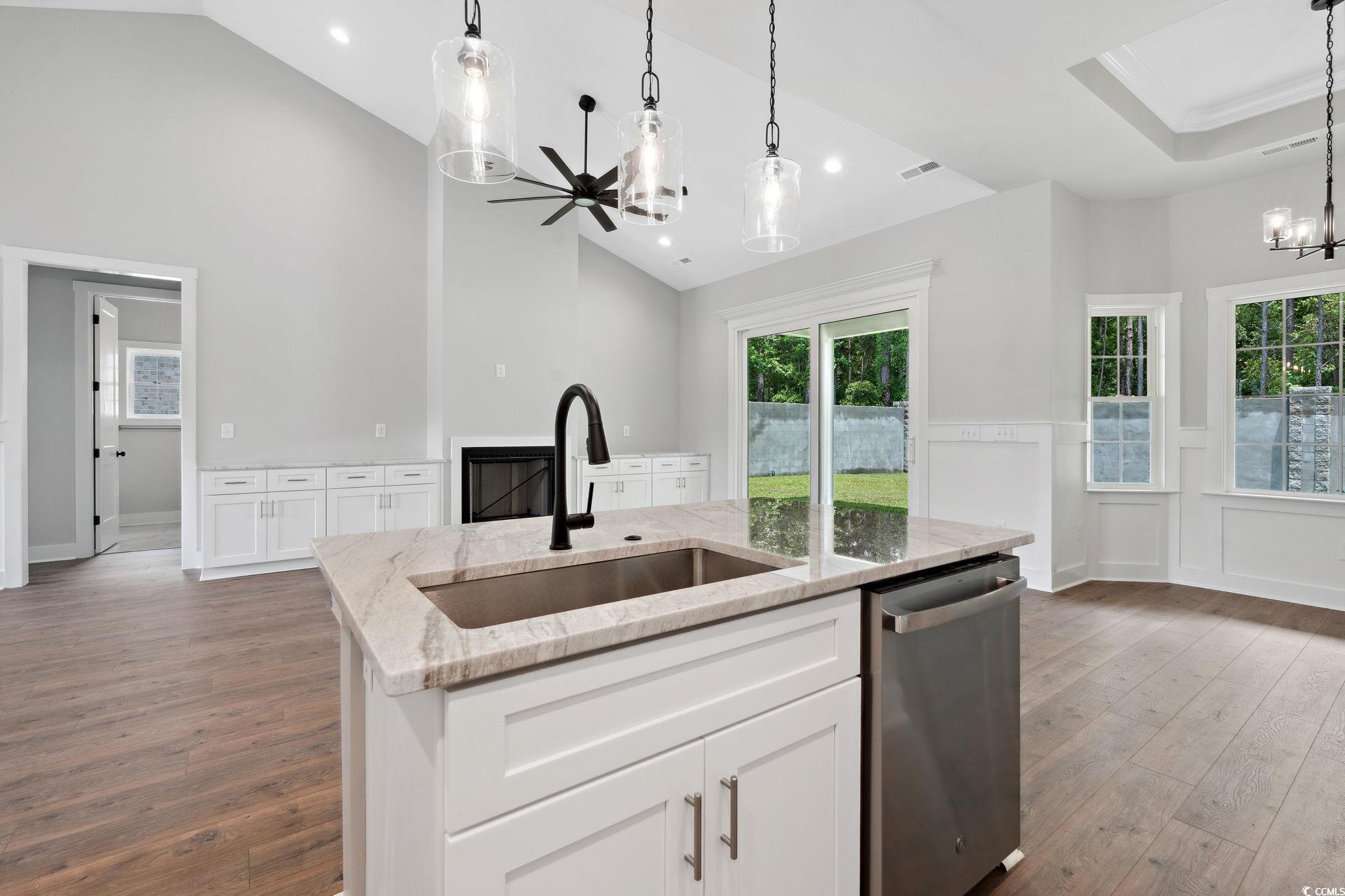 297 Waterfall Circle Little River, SC 29566 - Photo 15 of 40 Kitchen featuring dishwasher, a sink, a chandelier, dark wood-style flooring, and high vaulted ceiling