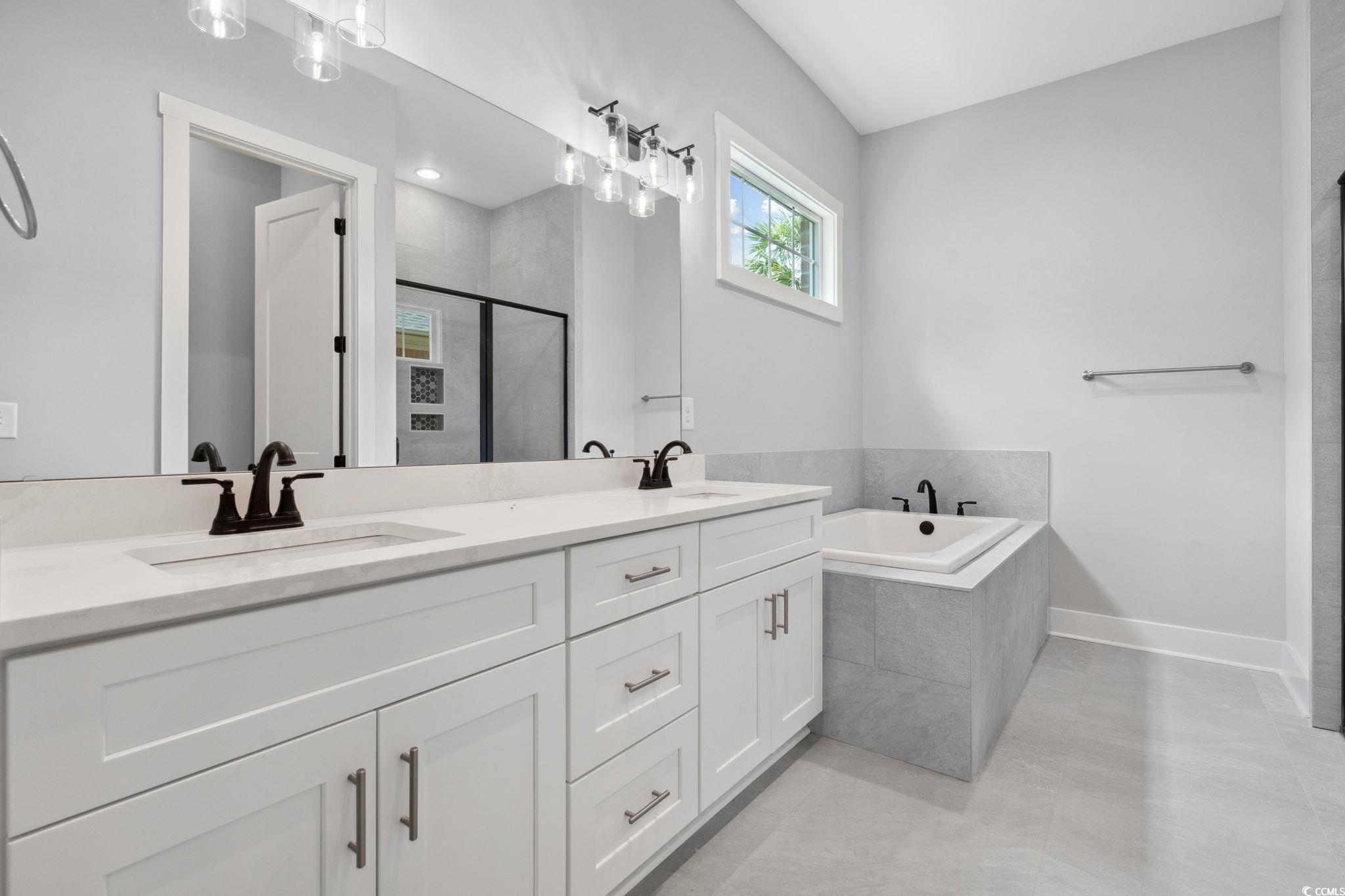 297 Waterfall Circle Little River, SC 29566 - Photo 22 of 40 Full bath with a stall shower, a garden tub, double vanity, and baseboards