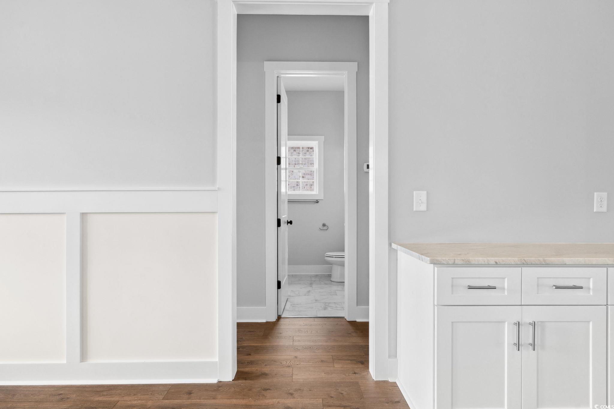297 Waterfall Circle Little River, SC 29566 - Photo 27 of 40 Hall with baseboards and wood finished floors