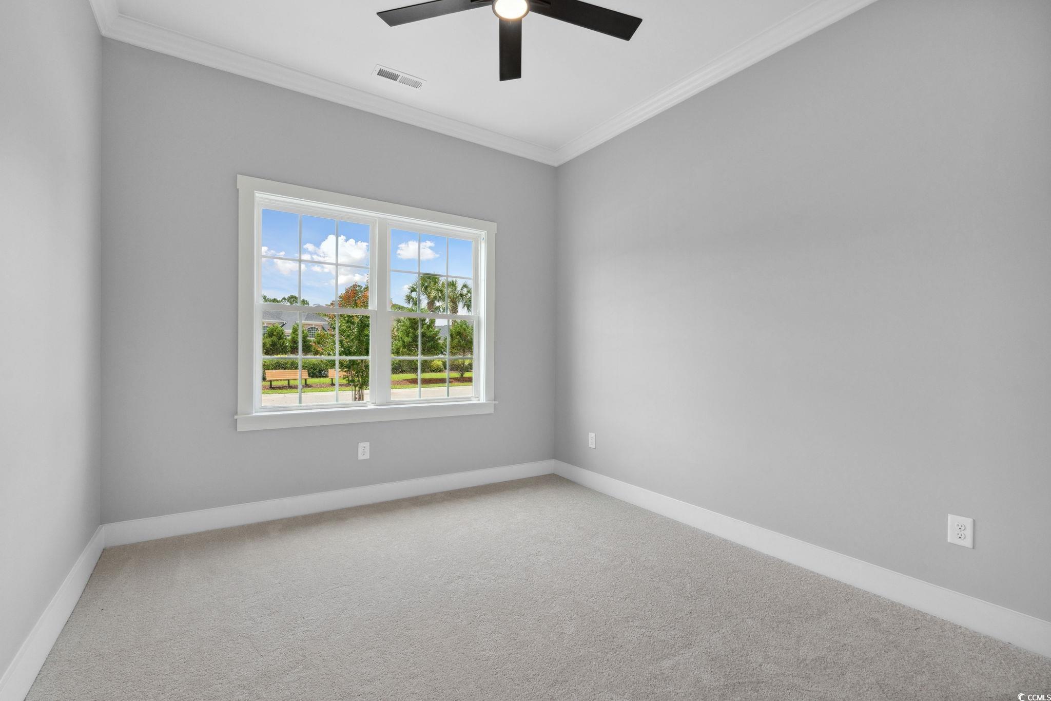 297 Waterfall Circle Little River, SC 29566 - Photo 32 of 40 Unfurnished room featuring carpet flooring, ceiling fan, ornamental molding, and baseboards