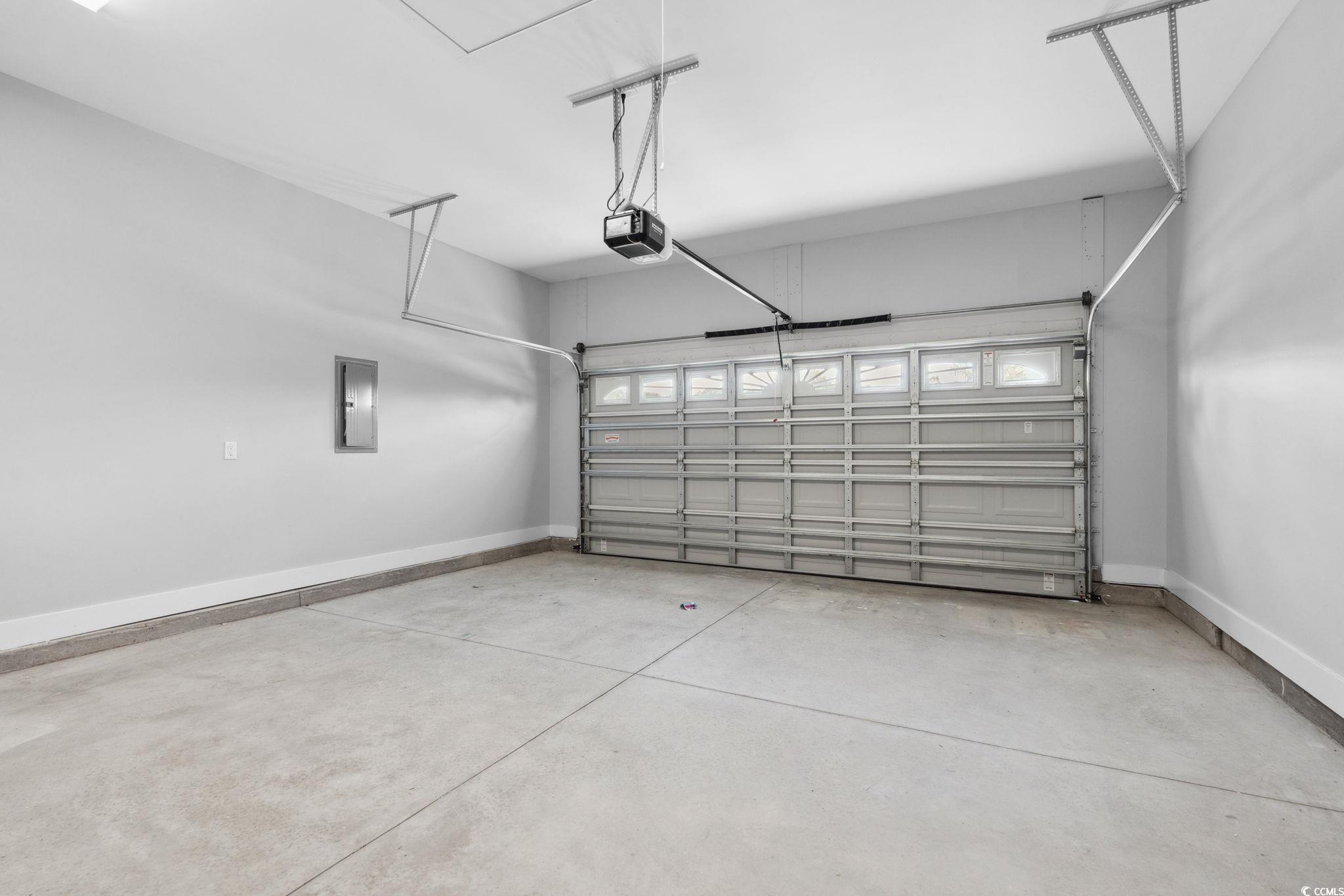 297 Waterfall Circle Little River, SC 29566 - Photo 34 of 40 Garage featuring electric panel, baseboards, and a garage door opener