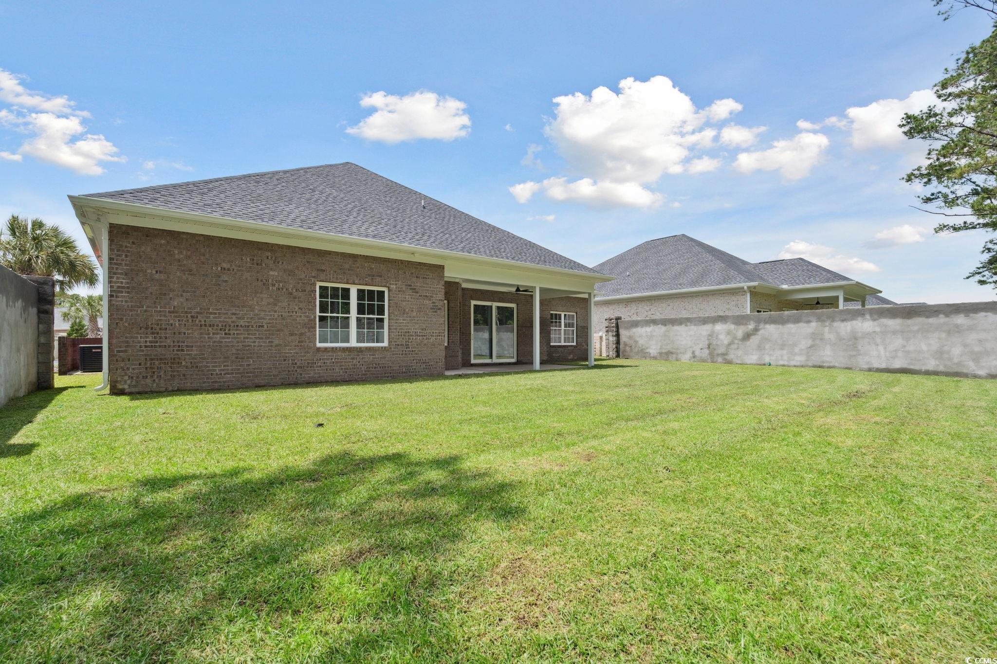 297 Waterfall Circle Little River, SC 29566 - Photo 35 of 40 Back of house with brick siding and roof with shingles