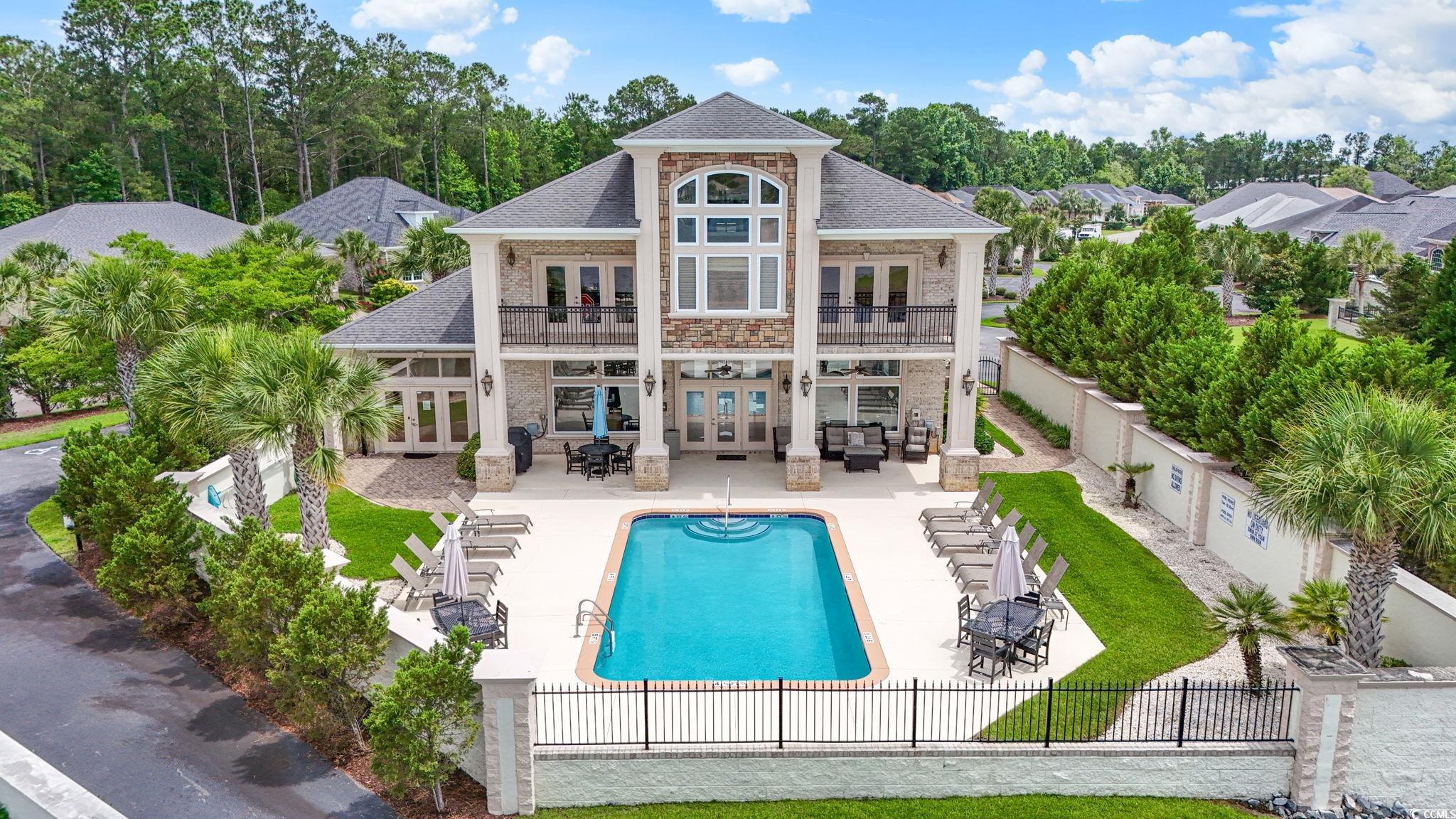 297 Waterfall Circle Little River, SC 29566 - Photo 40 of 40 Back of property featuring french doors, a balcony, a fenced backyard, an outdoor hangout area, and a patio area