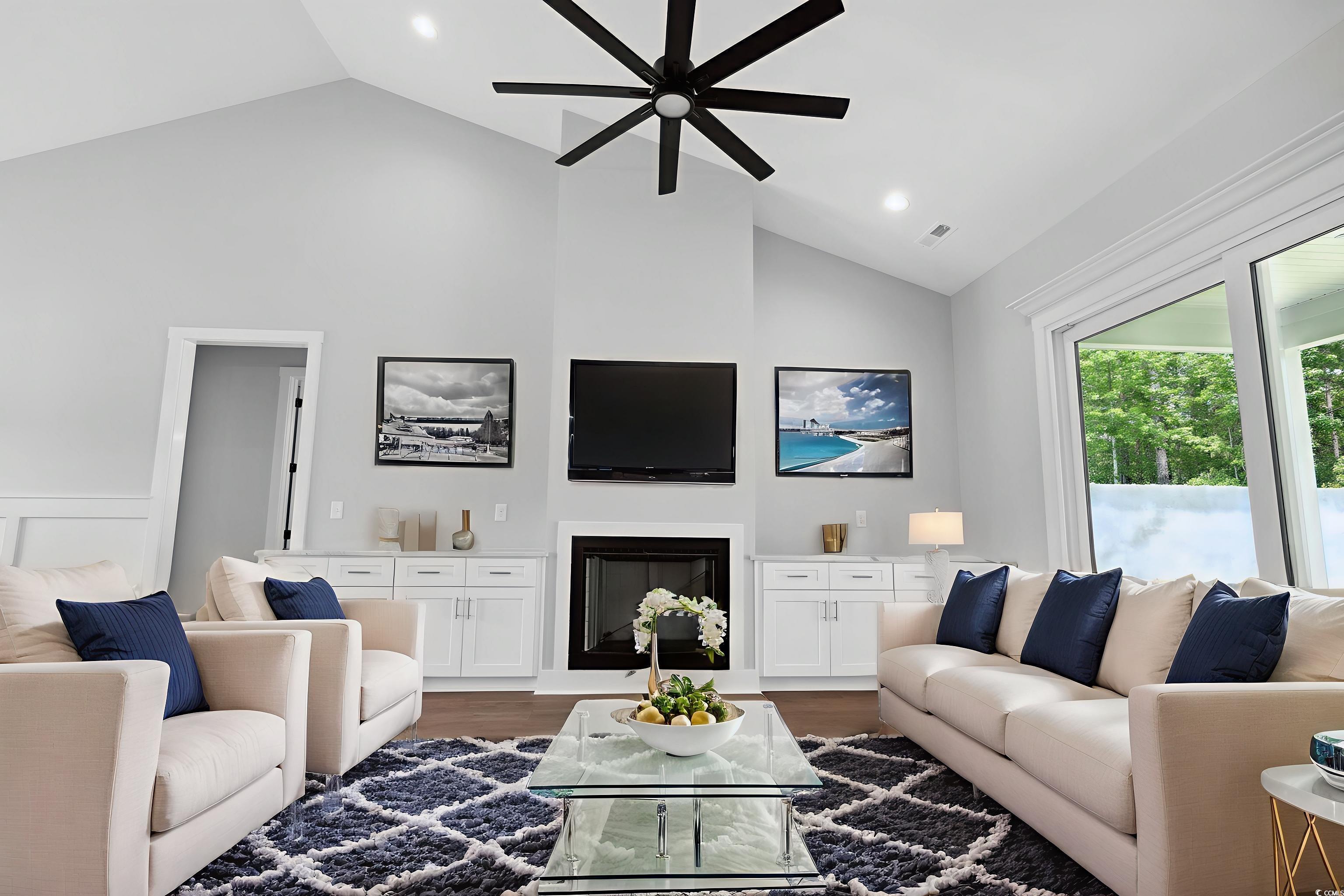 297 Waterfall Circle Little River, SC 29566 - Photo 9 of 40 Living area featuring lofted ceiling, wood finished floors, a glass covered fireplace, ceiling fan, and recessed lighting