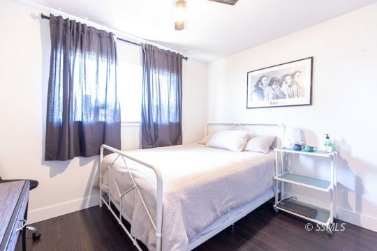1021 West Iowa Avenue Ridgecrest, CA 93555 - Photo 33 of 40 a bedroom with a bed and a chandelier