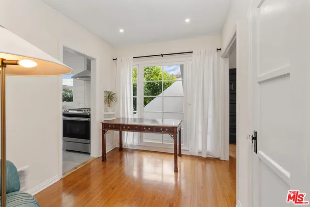 a kitchen with white cabinets and appliances