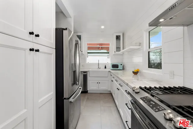 a kitchen with a stove and a window