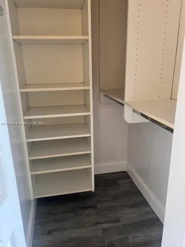 a bathroom with a granite countertop toilet sink and mirror