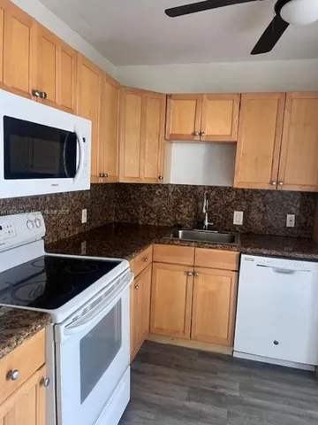 a kitchen with stainless steel appliances granite countertop a refrigerator stove a sink and dishwasher