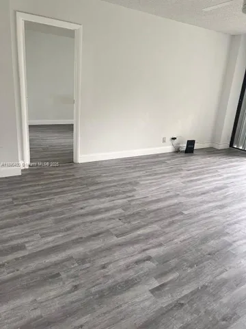 a view of an empty room and wooden floor