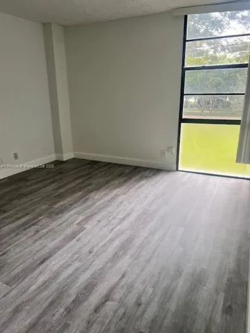 a view of a room with wooden floor