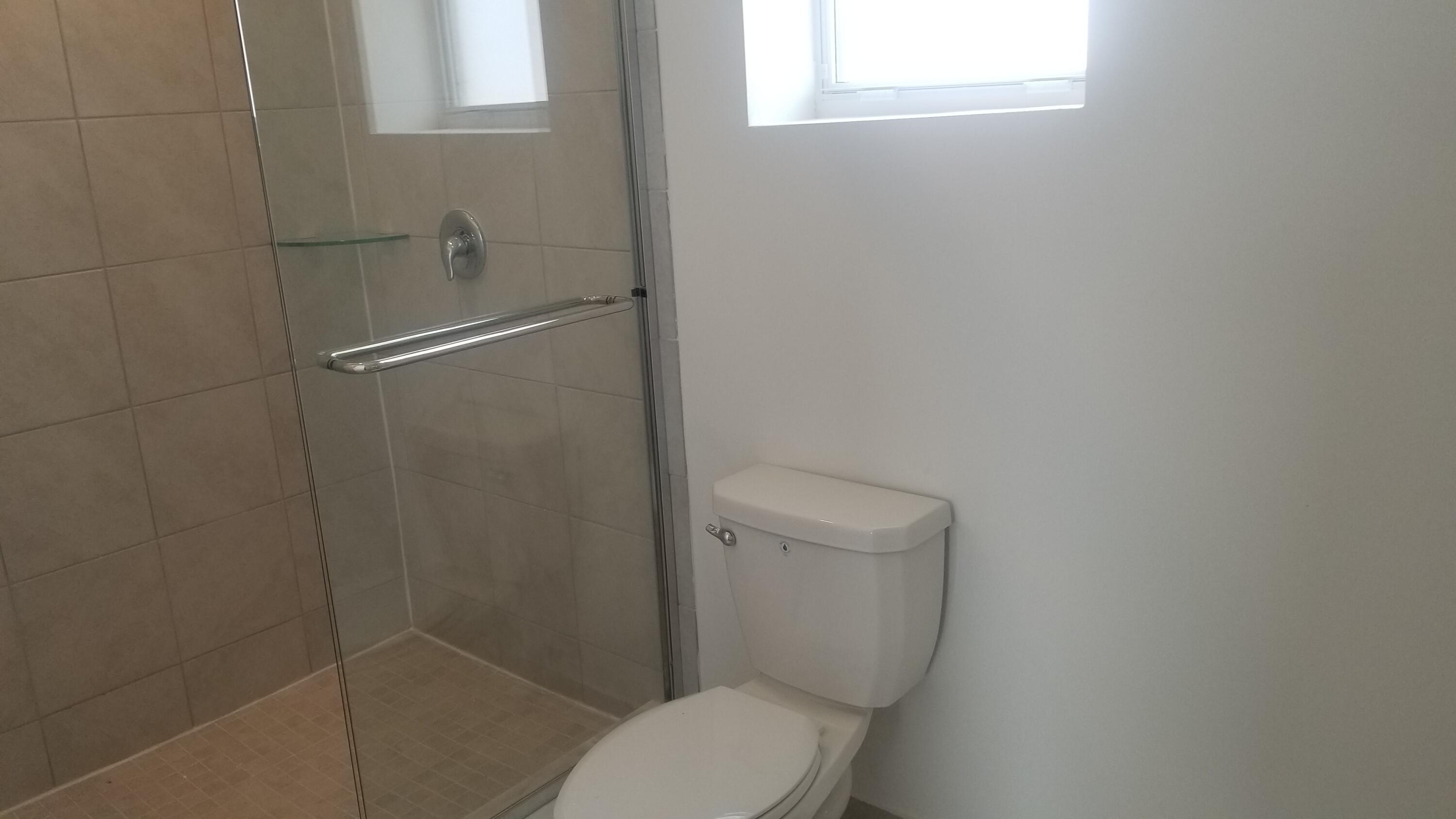 12736 Southwest 211th Street Miami, FL 33177 - Photo 11 of 18 a white toilet sitting next to a bathroom sink