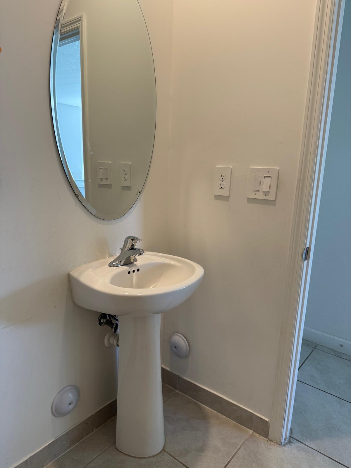 12736 Southwest 211th Street Miami, FL 33177 - Photo 15 of 18 a bathroom with a sink and mirror