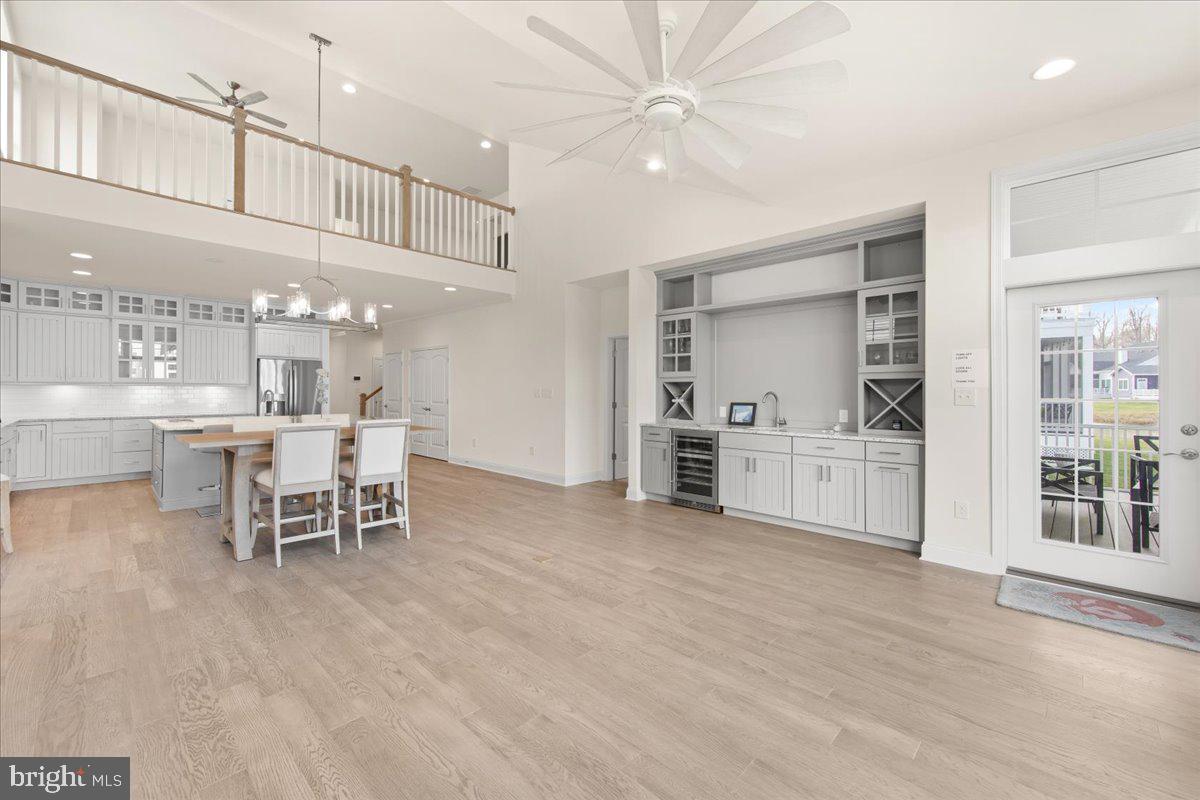 12193 Collins Road Lewes, DE 19958 - Photo 5 of 62 wet bar with built ins, sink and wine refrigerator