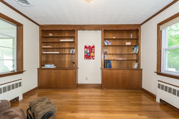 197 Evelyn Road Newton, MA 02468 - Photo 8 of 18 a view of a livingroom with shelves