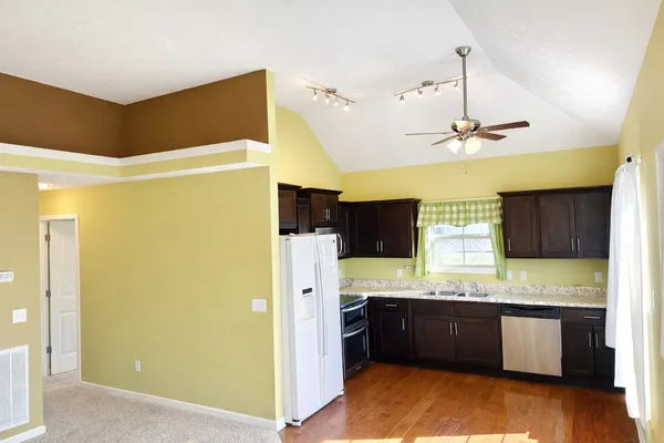 a view of an empty room with a window and a bathroom