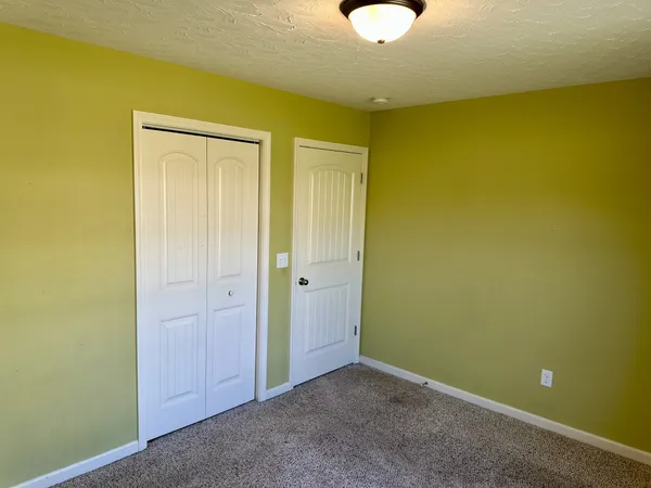 a view of an empty room with a ceiling fan