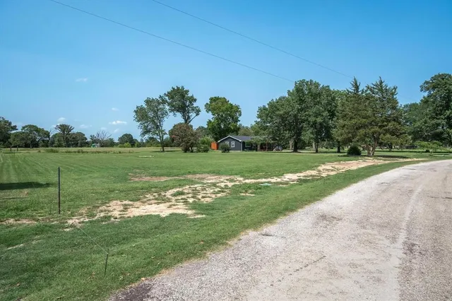 a view of a park and trees in the background
