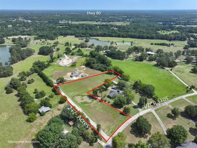 an aerial view of a golf course with parking space