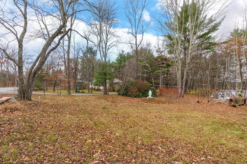 183 South Road Pepperell, MA 01463 - Photo 23 of 27 a backyard of a house with trees and houses