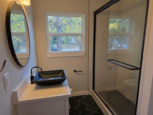 a bathroom with a sink and a window