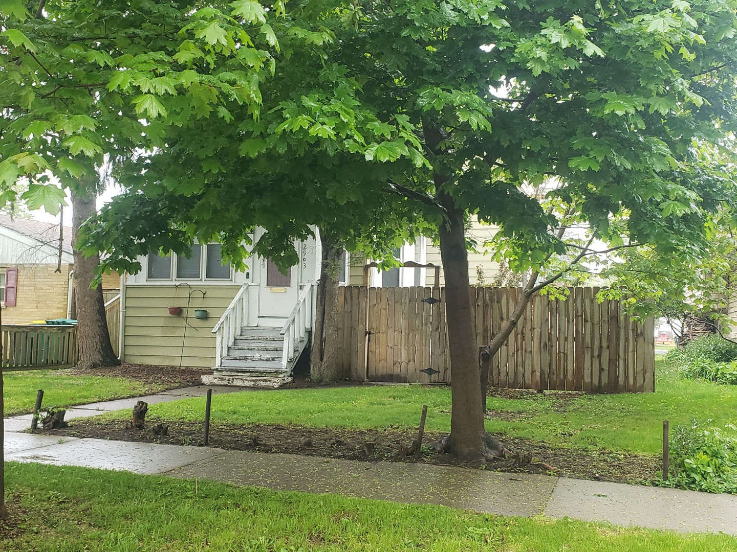 2903 Gideon Avenue Zion, IL 60099 - Photo 2 of 12 a view of a bench in a yard with wooden fence