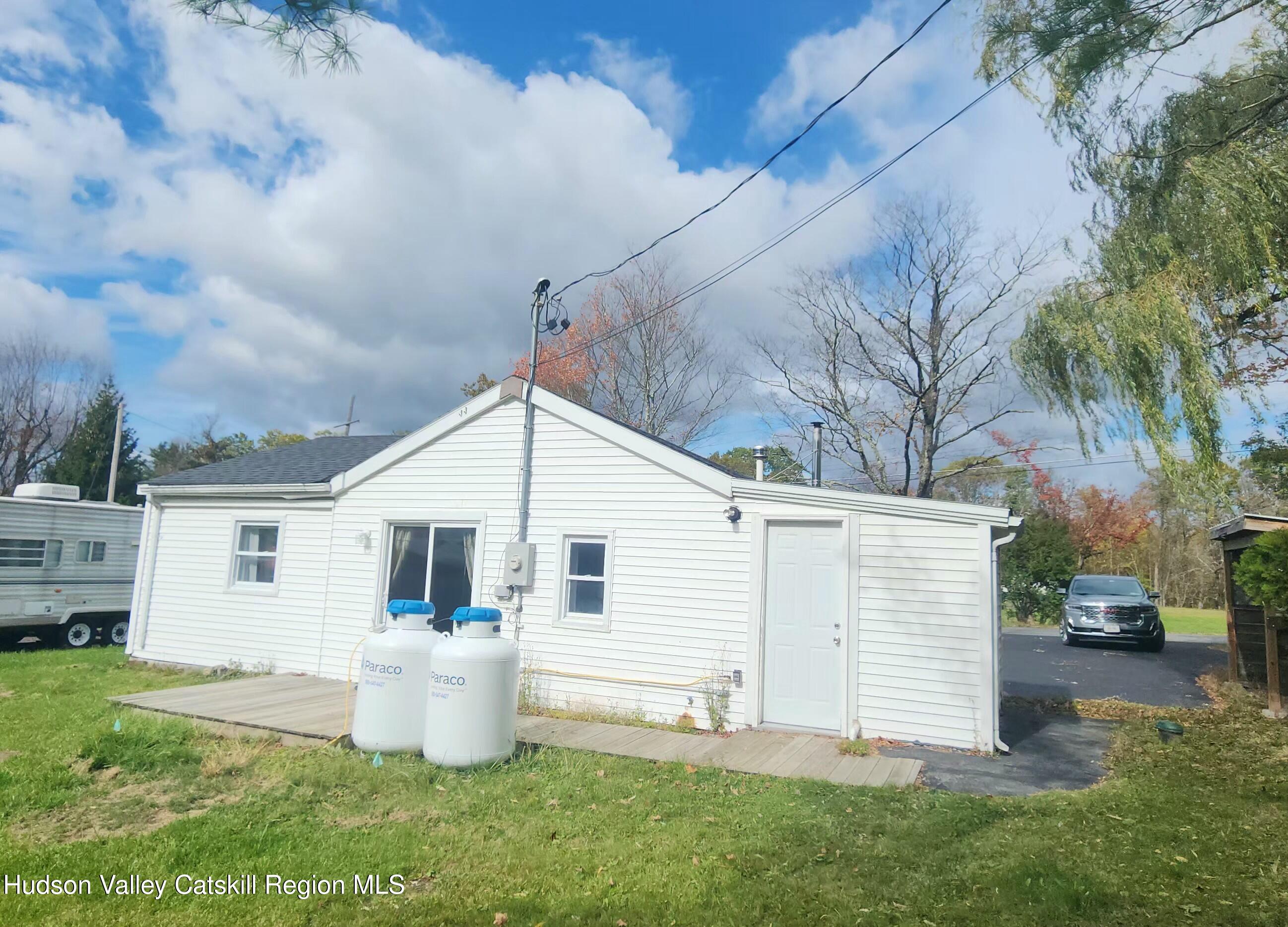 231 Stone Bridge Road Cornwallville, NY 12418 - Photo 16 of 18 a view of a house with a yard and sitting area