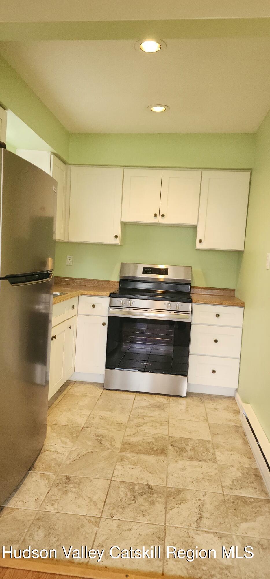 231 Stone Bridge Road Cornwallville, NY 12418 - Photo 3 of 18 a kitchen with stainless steel appliances granite countertop a stove a sink and a microwave