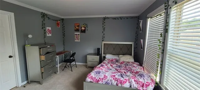 a bedroom with a bed and a chair in it