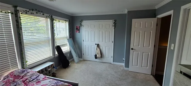 a view of a hallway with furniture and a window