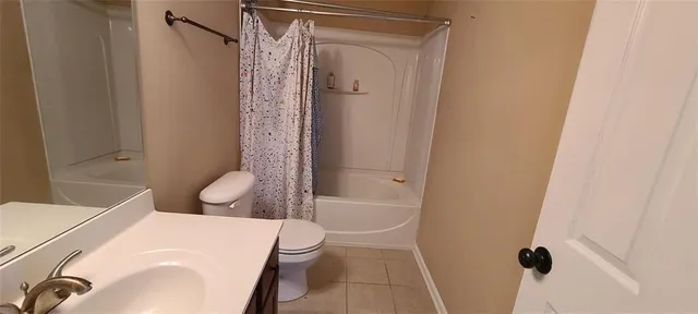 a white toilet sitting next to a bathroom sink and shower