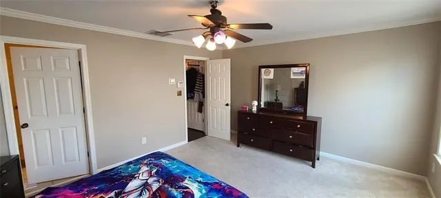 a bedroom with a bed and a dresser in it