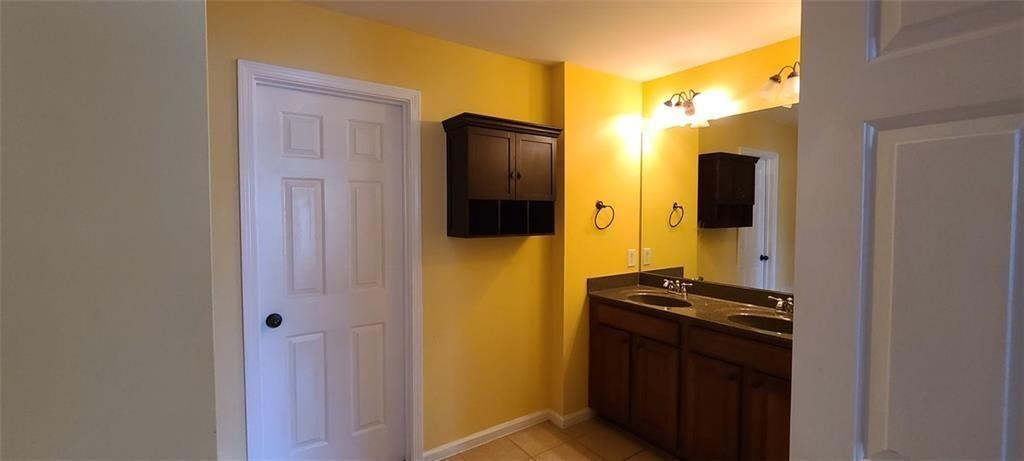4434 Lassen Court Suwanee, GA 30024 - Photo 24 of 46 a bathroom with a sink and a refrigerator