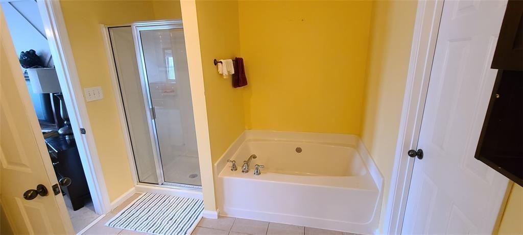 4434 Lassen Court Suwanee, GA 30024 - Photo 25 of 46 a bathroom with a tub and a shower