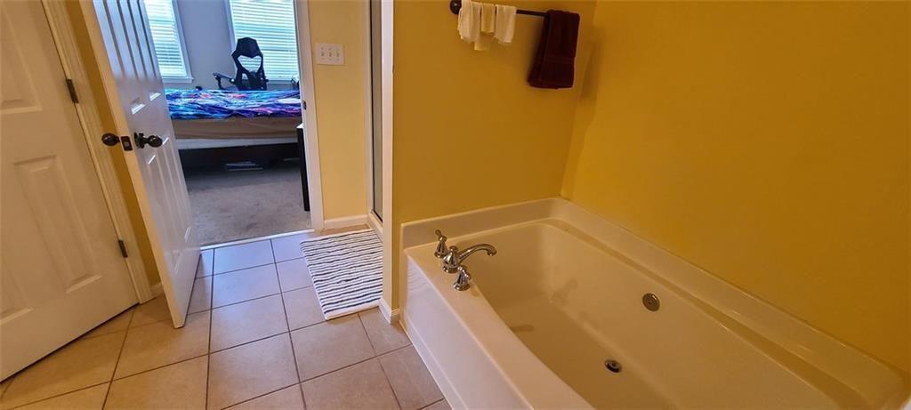 4434 Lassen Court Suwanee, GA 30024 - Photo 27 of 46 a bathroom with a tub