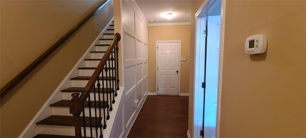 4434 Lassen Court Suwanee, GA 30024 - Photo 29 of 46 a view of a hallway with wooden floor and stairs