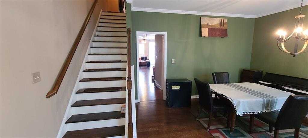 4434 Lassen Court Suwanee, GA 30024 - Photo 3 of 46 a view of a dining room with furniture and wooden floor