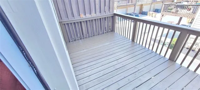 a view of a balcony with wooden floor