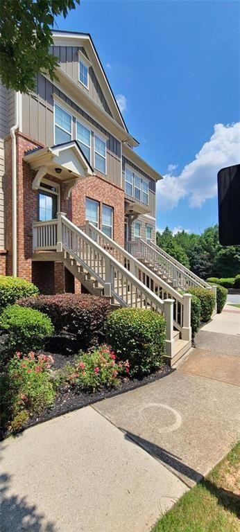 4434 Lassen Court Suwanee, GA 30024 - Photo 45 of 46 a front view of a house with a garden
