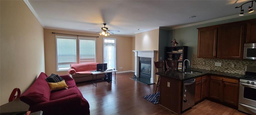4434 Lassen Court Suwanee, GA 30024 - Photo 7 of 46 a living room with furniture window and wooden floor