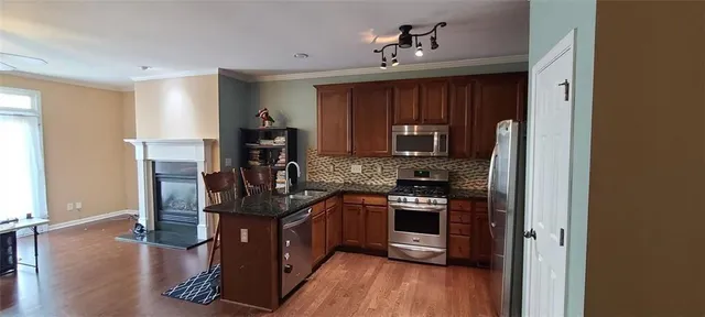a kitchen with stainless steel appliances granite countertop a stove and cabinets